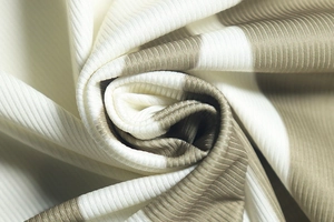 Close-up of ribbed knit fabric showing vertical textures and cream-brown stripe pattern