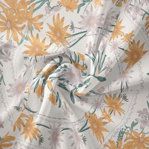 Detail view of white fabric with mandala floral patterns and soft texture folds