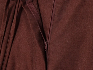 Macro shot of dark brown fabric texture with matching high-quality zipper detail
