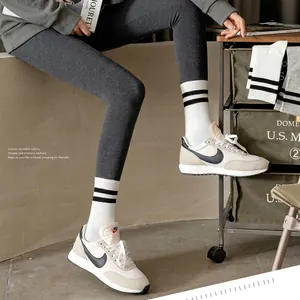 Classic white athletic crew socks with two black stripes in a stylish casual sport look