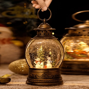 Vintage bronze Christmas lantern with spinning snow, warm lights, and festive pine trees