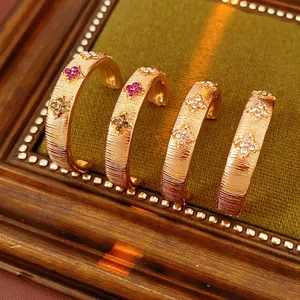 Gold brushed C-shape earrings set with multi-color clover floral zircon stones