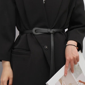 Minimalist black slim waist belt for women, shown knotted over a formal black blazer