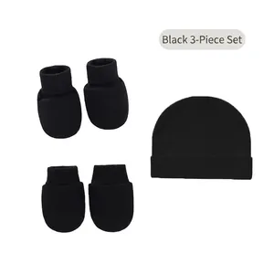 Detail of soft black cotton 3-piece set including baby beanie and matching mittens