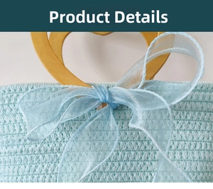 Detail of light blue woven bag featuring a heart-shaped wooden handle and silk bow