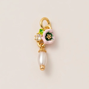 Detail of 18K gold plated earring pendant with pink flower, green leaf and white pearl
