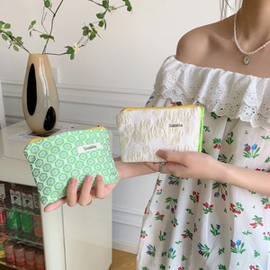 Floral and jacquard drawstring cosmetic bags in green and cream cotton fabric