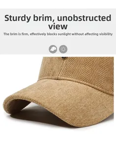 Detail of brown herringbone corduroy baseball cap showing the stiff visor and fabric texture