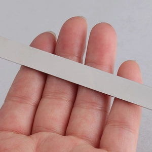 Close-up of a silver mirror-finish stainless steel rectangular strip for DIY cuff bracelet