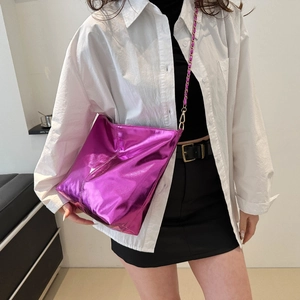 Fashionable metallic rose red bucket bag for women with chain strap in studio