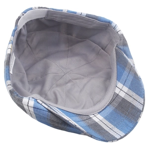 Detail view of the colorful plaid beret interior with lining and polyester material label