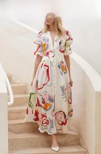 Close-up of V-neck floral summer dress with puff sleeves and colorful artistic flower prints