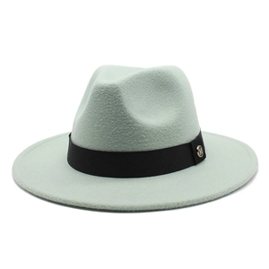Detail of mint green wool fedora hat with black ribbon and golden M metal emblem