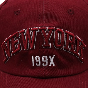 Detailed 3D embroidery of NEW YORK lettering on dark red cotton twill baseball cap