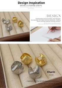 Detailed view of textured square metal huggie earrings in gold and silver finishes