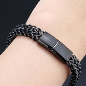 Close-up of black braided stainless steel hip-hop bracelet with smooth magnetic clasp