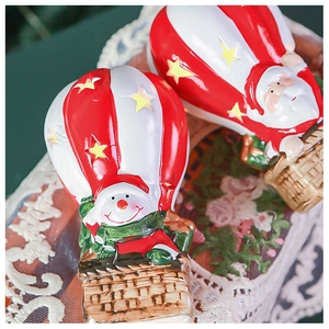 Illuminated Santa and Snowman hot air balloon decor on vintage lace and rose fabric