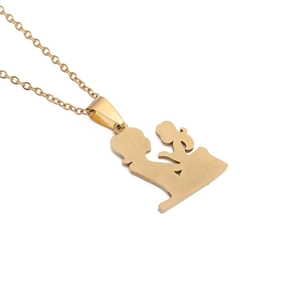 Detail of gold-plated mother and daughter silhouette pendant necklace on white background