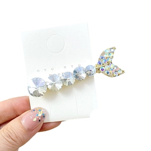 Sparkling mermaid tail hair clip with K9 crystals and rhinestones on a white card