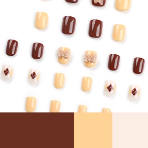 Press on nails set featuring golden bear, bow tie accents, and brown grid patterns