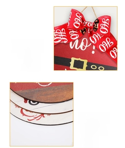 Detail view of wooden Christmas sign featuring red HO HO HO bow and Santa belt pattern