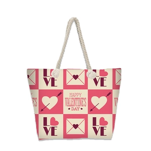 Detail view of Valentine's Day canvas tote with cotton rope handles and love prints