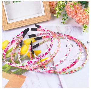 Detailed view of floral fabric wrapped headbands with protective black non-slip ends