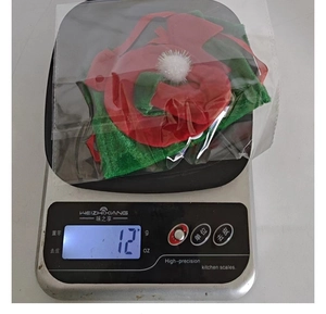 Detailed view of lightweight 12g Christmas wine bottle cover in packaging for festive decor