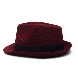 Detailed texture of dark red trilby hat with black decorative ribbon band