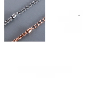 Detail of silver and rose gold intertwined chains with adjustable drop endings
