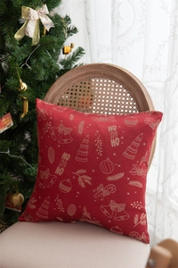Close-up of red Christmas pillow with gold tree and HO HO HO pattern on a chair