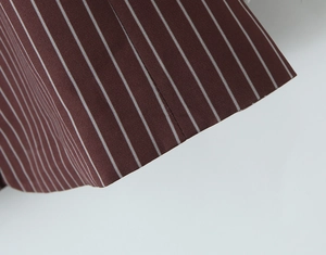 Close-up of brown British style blazer fabric with white pinstripe texture detail