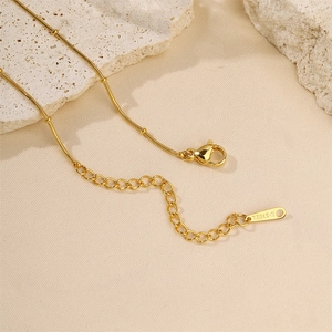 Minimalist 18k gold plated stainless steel sunflower bracelet on natural stone background