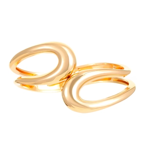 Detailed macro view of gold-tone irregular alloy cuff with a fluid streamlined design