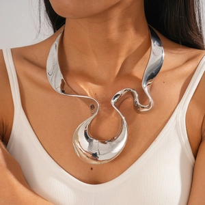 Macro detail of silver liquid metal choker featuring irregular twisted geometric design
