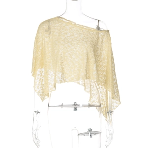 Detailed view of light yellow sheer lace shawl with irregular one-shoulder design
