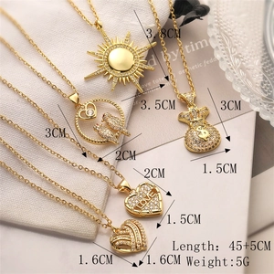 Detailed view of five gold-plated necklaces featuring various heart and bird pendants