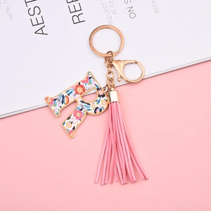 Detail of floral letter R keychain with pink tassel and gold-tone lobster clasp hardware