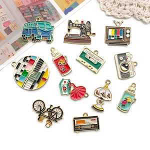 Flat lay of vintage enamel alloy charms including sewing machine and camera for DIY jewelry