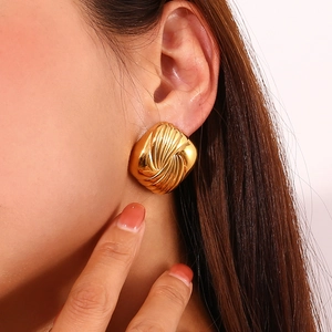 Macro shot of 18K gold plated square stud earring with vintage rippled wing texture
