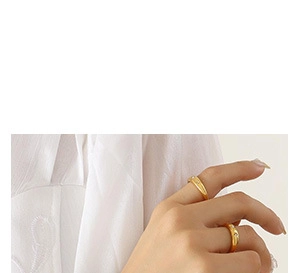 Detailed view of two minimalist gold-plated rings with small sparkling zircon stones