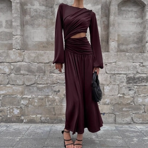 Detail of burgundy satin dress showing side cut-out and elegant ruched textures
