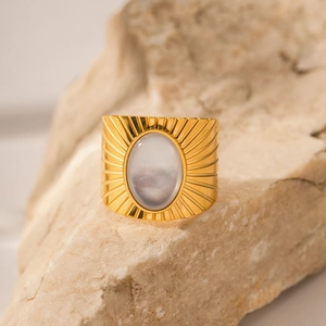 Vintage wide gold ring with oval African pine stone and sunburst engraving on rock
