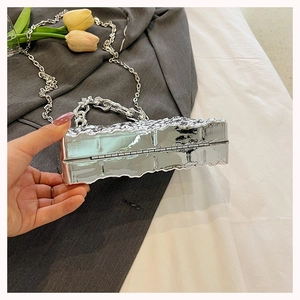 Silver acrylic box bag with wrinkled metallic texture and chunky silver chain handle