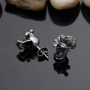 Detailed close-up of skull stud earrings with silver finish and sparkling crystal eyes