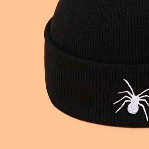 Winter black ribbed knit beanie with white spider embroidery in streetwear style