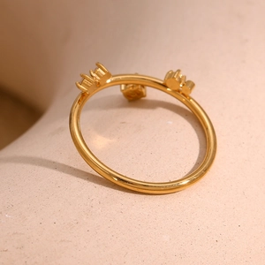 Macro detail of gold-plated crown ring with three micro-set clear zircon stones