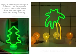 Detail of LED neon Christmas tree and palm tree lamps with round white bases for desktop