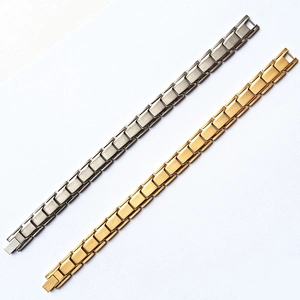 Detail of gold and silver titanium steel magnetic bracelets with beveled link design