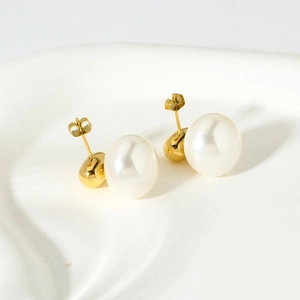 Detailed view of geometric pearl studs on white ceramic with 16K gold finish